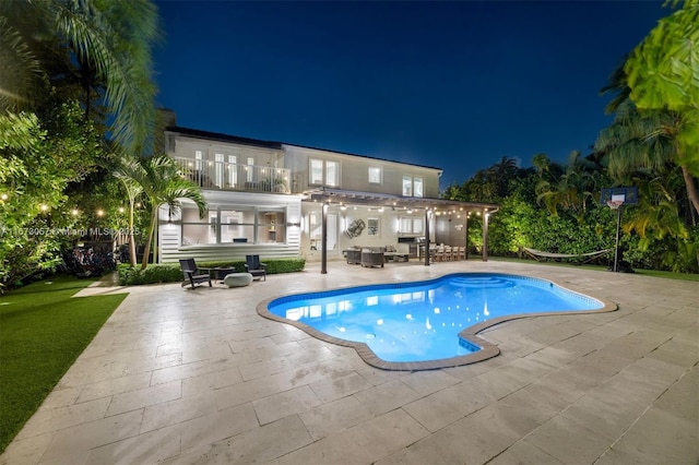 pool at night with a patio