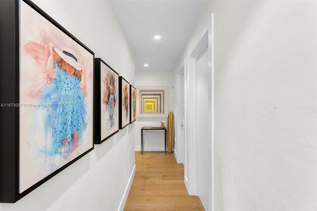 corridor with light hardwood / wood-style flooring