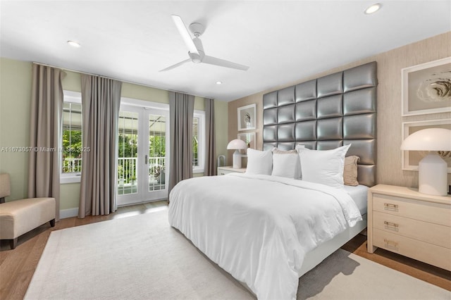 bedroom with access to exterior, light hardwood / wood-style flooring, french doors, and ceiling fan