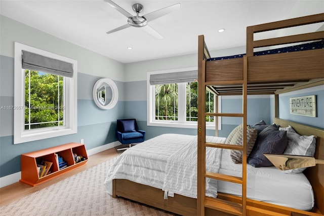 bedroom with multiple windows and ceiling fan