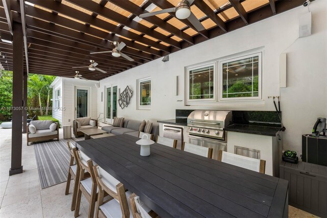 view of patio / terrace featuring an outdoor hangout area, grilling area, ceiling fan, and an outdoor kitchen