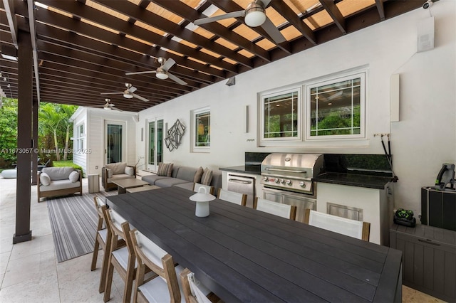 view of patio / terrace with a grill, an outdoor living space, ceiling fan, and exterior kitchen