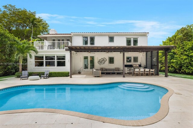 back of house with a pergola, a patio area, outdoor lounge area, and a balcony