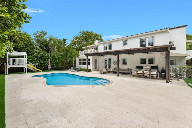 view of swimming pool with an outdoor living space and a patio area