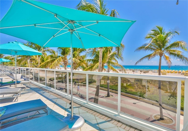 view of pool featuring a water view and a beach view