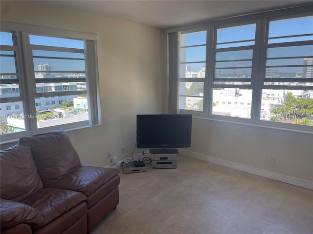 living room featuring baseboards and a wealth of natural light