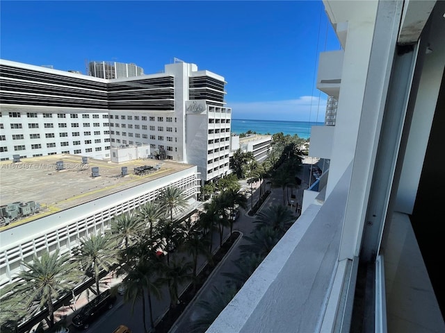 balcony with central AC unit and a water view