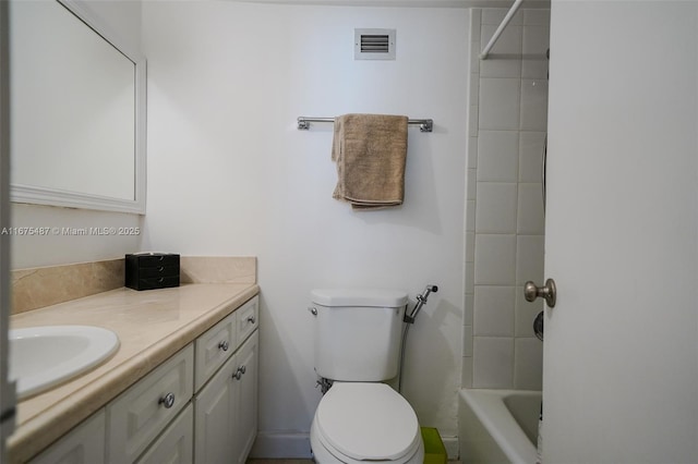 bathroom featuring visible vents, toilet, and vanity