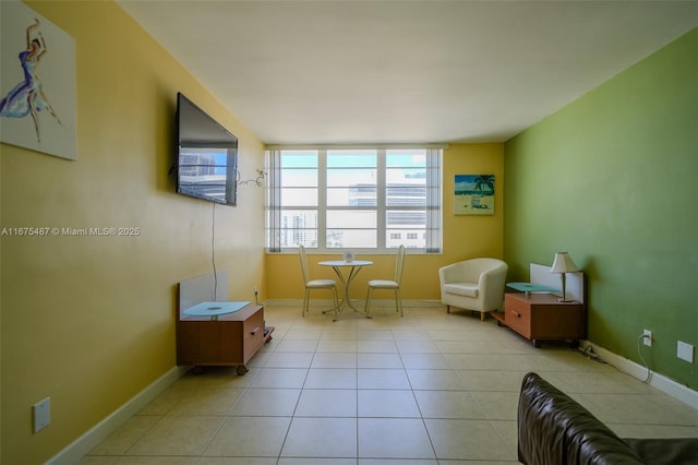 living area featuring tile patterned floors and baseboards