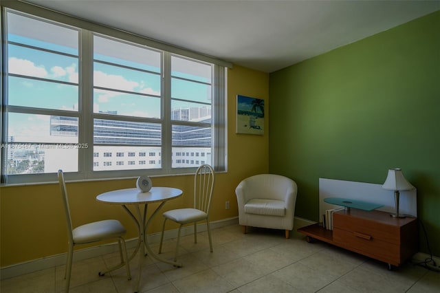 sitting room with light tile patterned floors and baseboards