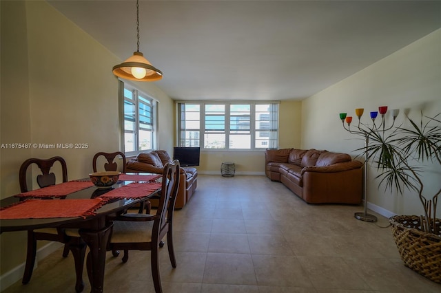 dining area featuring baseboards and tile patterned flooring