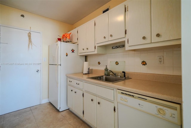 kitchen featuring white appliances, light tile patterned flooring, a sink, light countertops, and tasteful backsplash