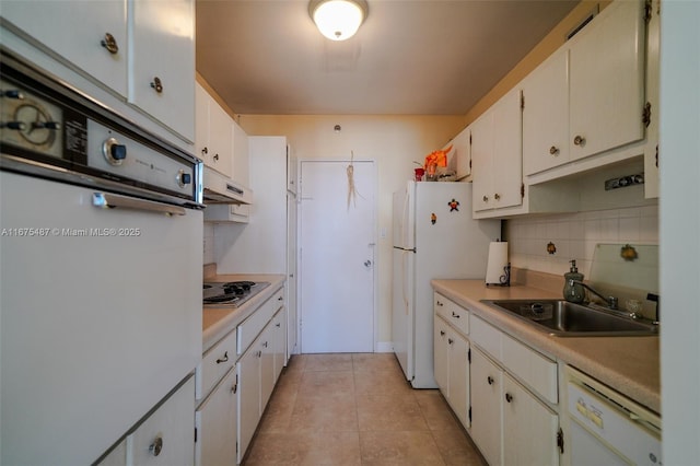 kitchen with a sink, under cabinet range hood, white appliances, light tile patterned floors, and decorative backsplash