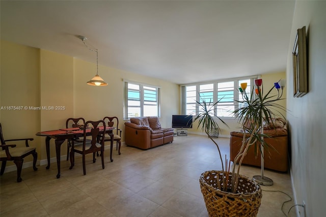 living area featuring baseboards