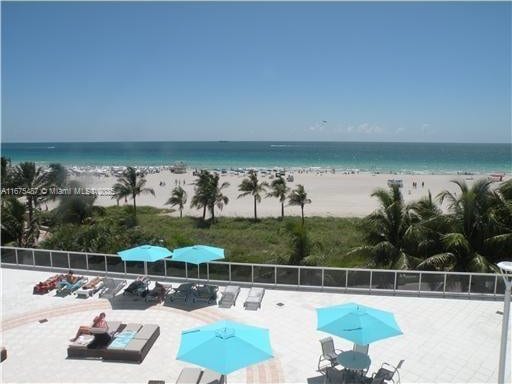 view of water feature with a view of the beach and fence