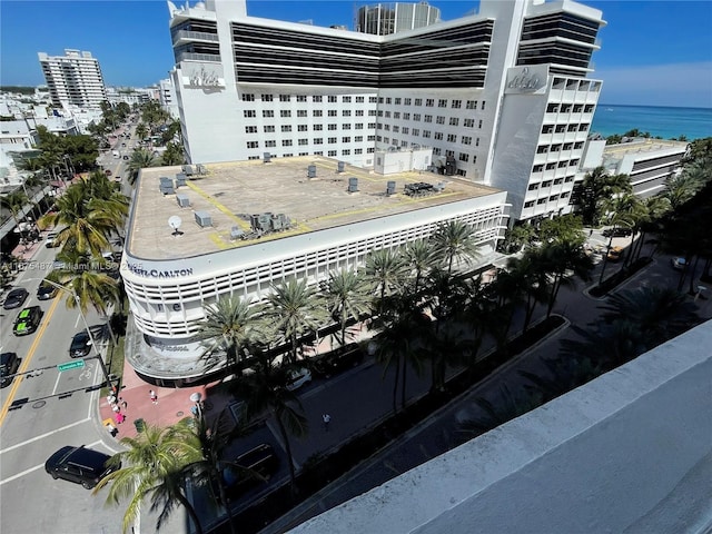 view of building exterior with a city view and a water view