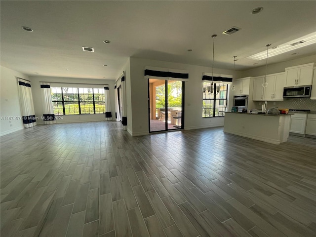 unfurnished living room with dark hardwood / wood-style floors