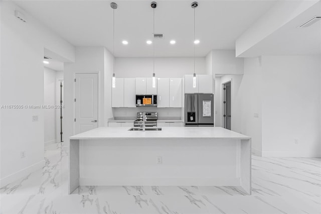 kitchen featuring pendant lighting, an island with sink, white cabinets, and appliances with stainless steel finishes