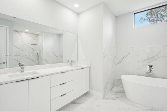 bathroom with a tub to relax in and vanity