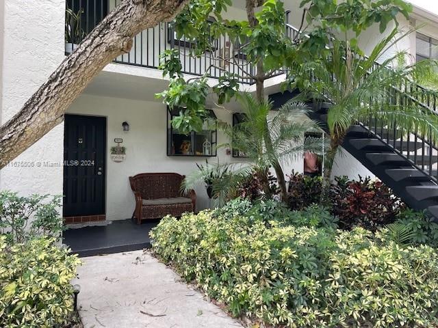 view of exterior entry featuring a balcony