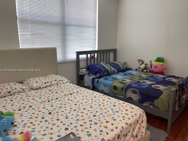 bedroom with hardwood / wood-style floors