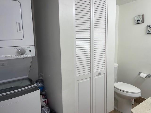 laundry area featuring stacked washer / drying machine