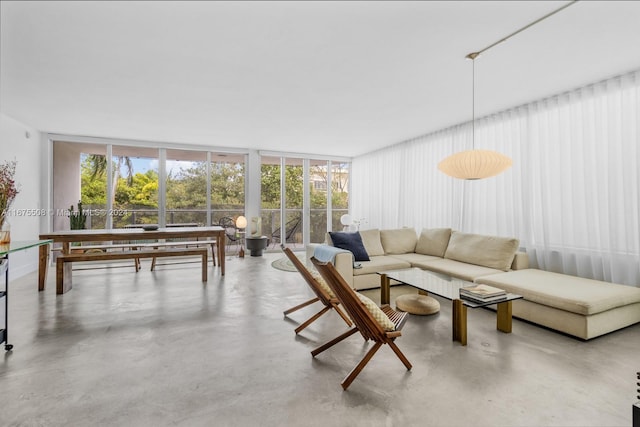 living room featuring concrete flooring and floor to ceiling windows