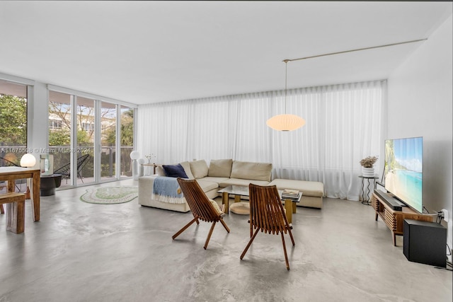 living room featuring a wall of windows and concrete floors