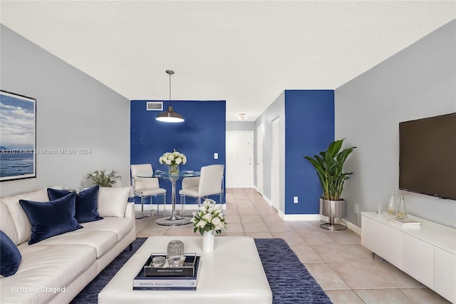 living room with light tile patterned floors and a textured ceiling