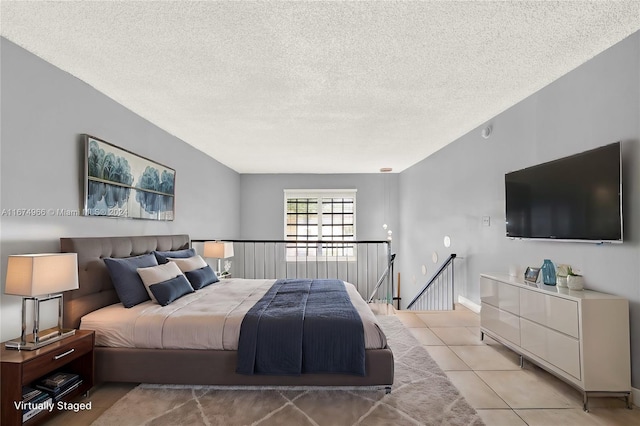 tiled bedroom featuring a textured ceiling