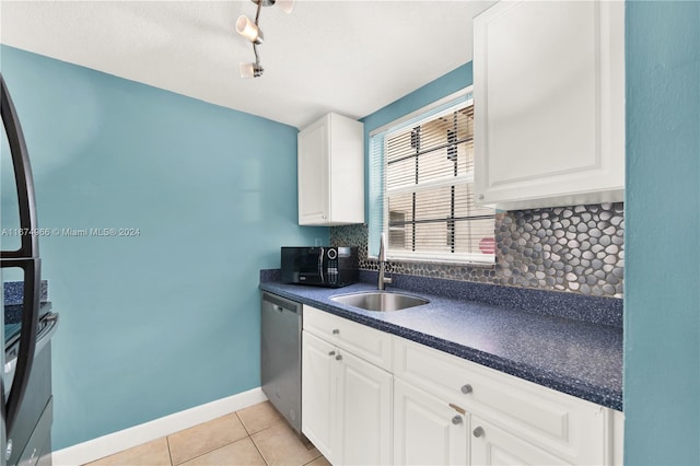 kitchen with stainless steel dishwasher, sink, decorative backsplash, white cabinets, and light tile patterned floors