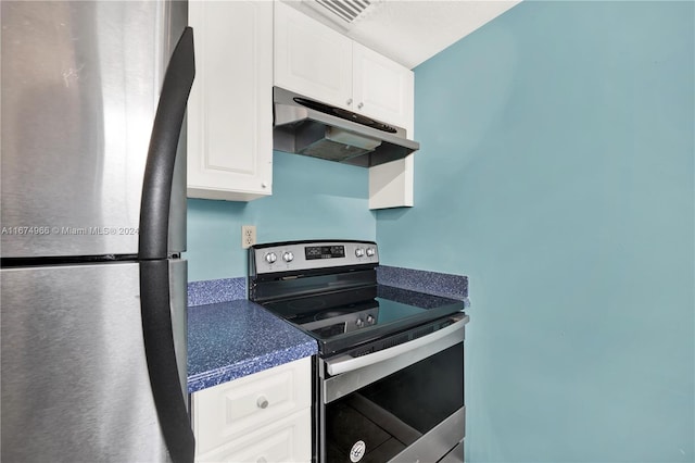 kitchen with stainless steel appliances and white cabinets