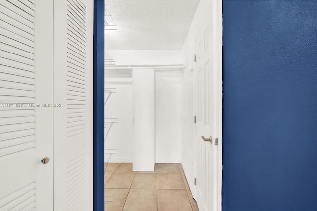 spacious closet featuring light tile patterned floors