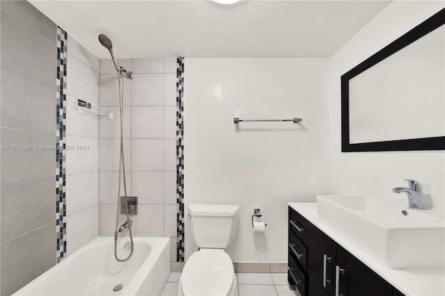 full bathroom featuring tiled shower / bath combo, vanity, tile patterned flooring, and toilet