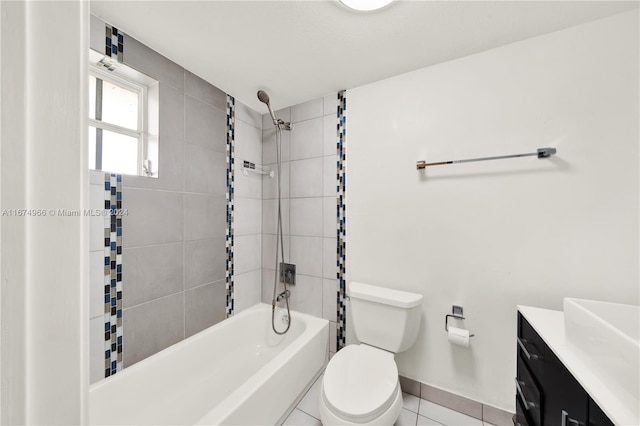 full bathroom featuring tiled shower / bath, tile patterned floors, vanity, and toilet