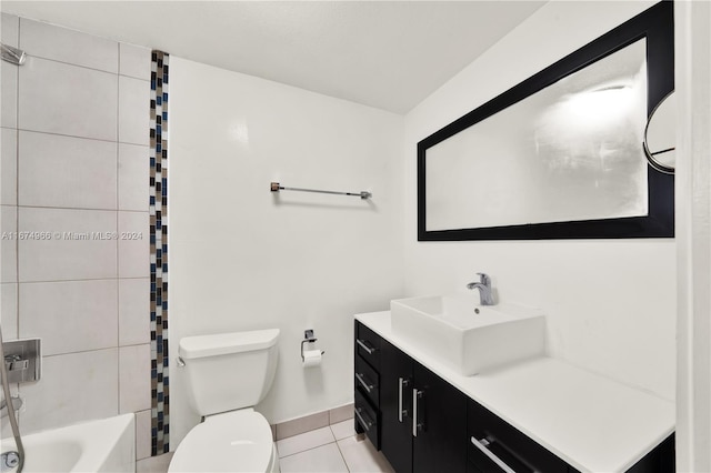 full bathroom featuring tile patterned flooring, tiled shower / bath combo, vanity, and toilet