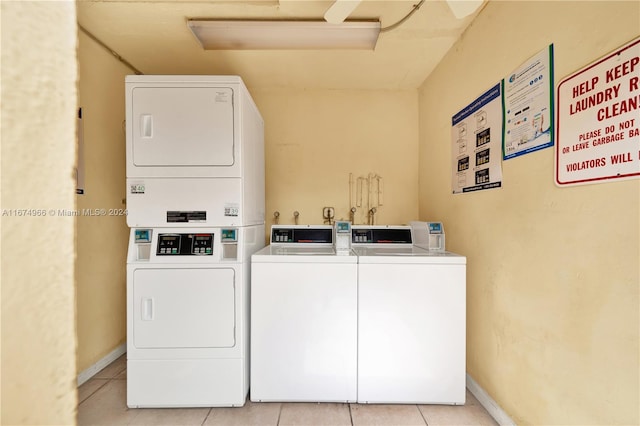 washroom featuring stacked washer / dryer and light tile patterned floors