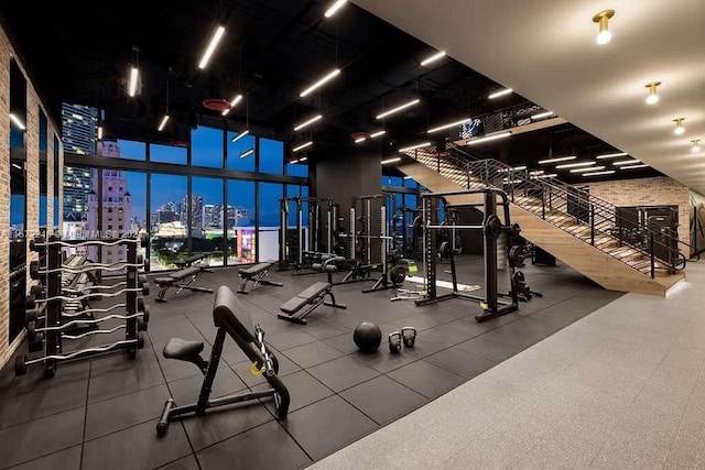 gym with a high ceiling and floor to ceiling windows