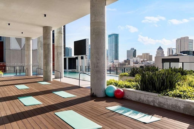 exercise room featuring floor to ceiling windows, light wood-type flooring, and a healthy amount of sunlight