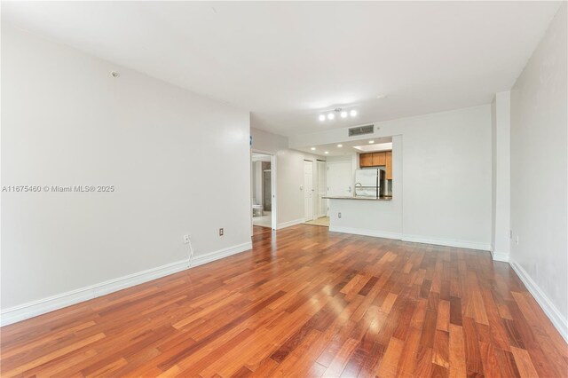 unfurnished living room featuring hardwood / wood-style floors