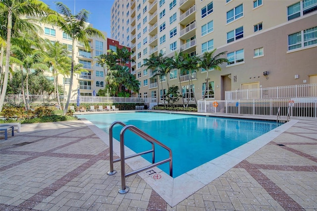 pool featuring a patio area and fence