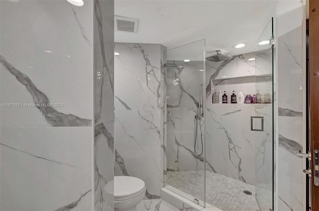 bathroom with walk in shower and toilet