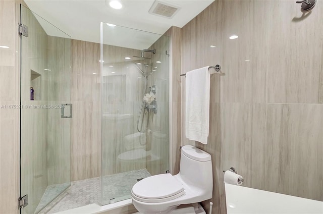 bathroom with walk in shower and toilet