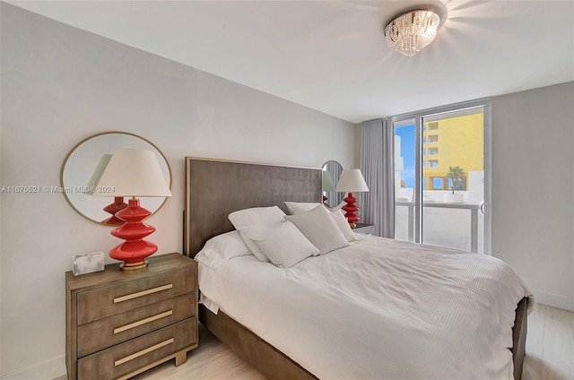 bedroom featuring access to outside and light hardwood / wood-style floors