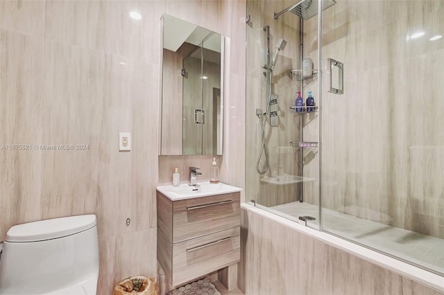 bathroom with walk in shower, toilet, tile patterned floors, tile walls, and vanity