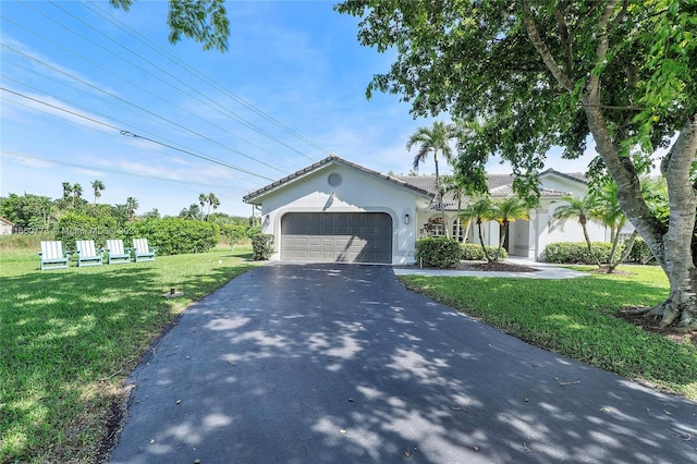 view of front of home with a front yard and a garage