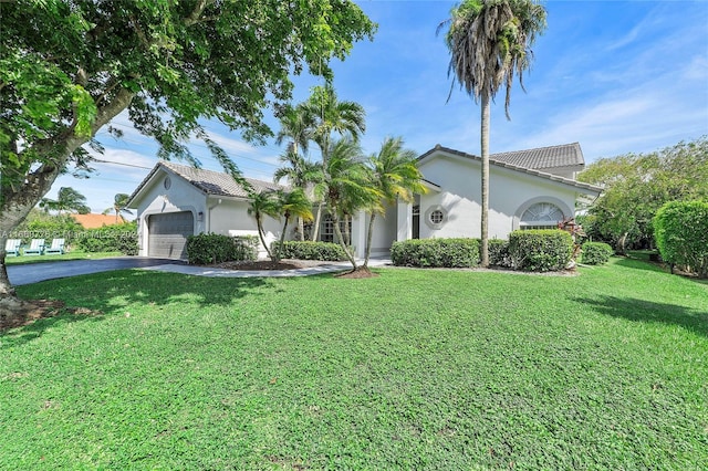 view of front of property with a garage and a front lawn