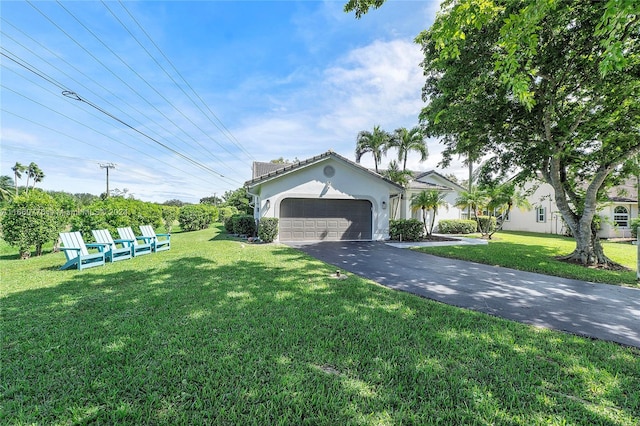 view of front of house featuring a garage and a front lawn