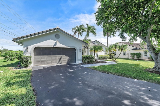 view of front facade featuring a front yard and a garage