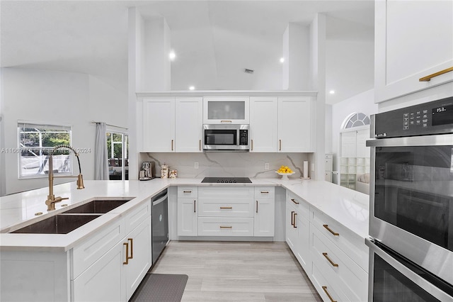 kitchen featuring appliances with stainless steel finishes, kitchen peninsula, and white cabinetry